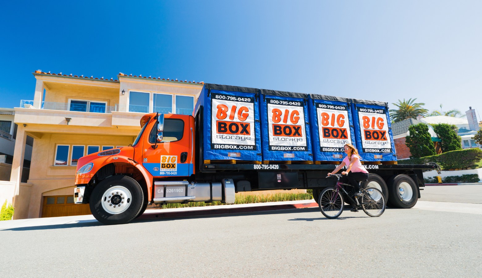 woman riding bike in front of san diego storage truck from Big Box Storage