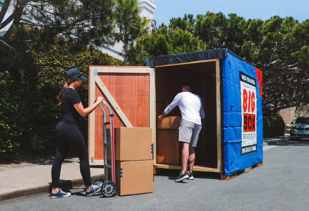 Loading boxes into a Big Box Storage unit, showcasing convenient self-storage locations